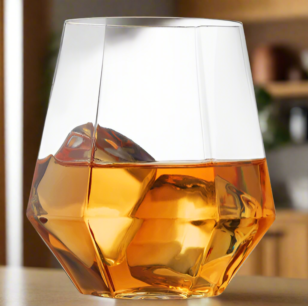 Dodecagonal glass filled with amber liquid on a white background